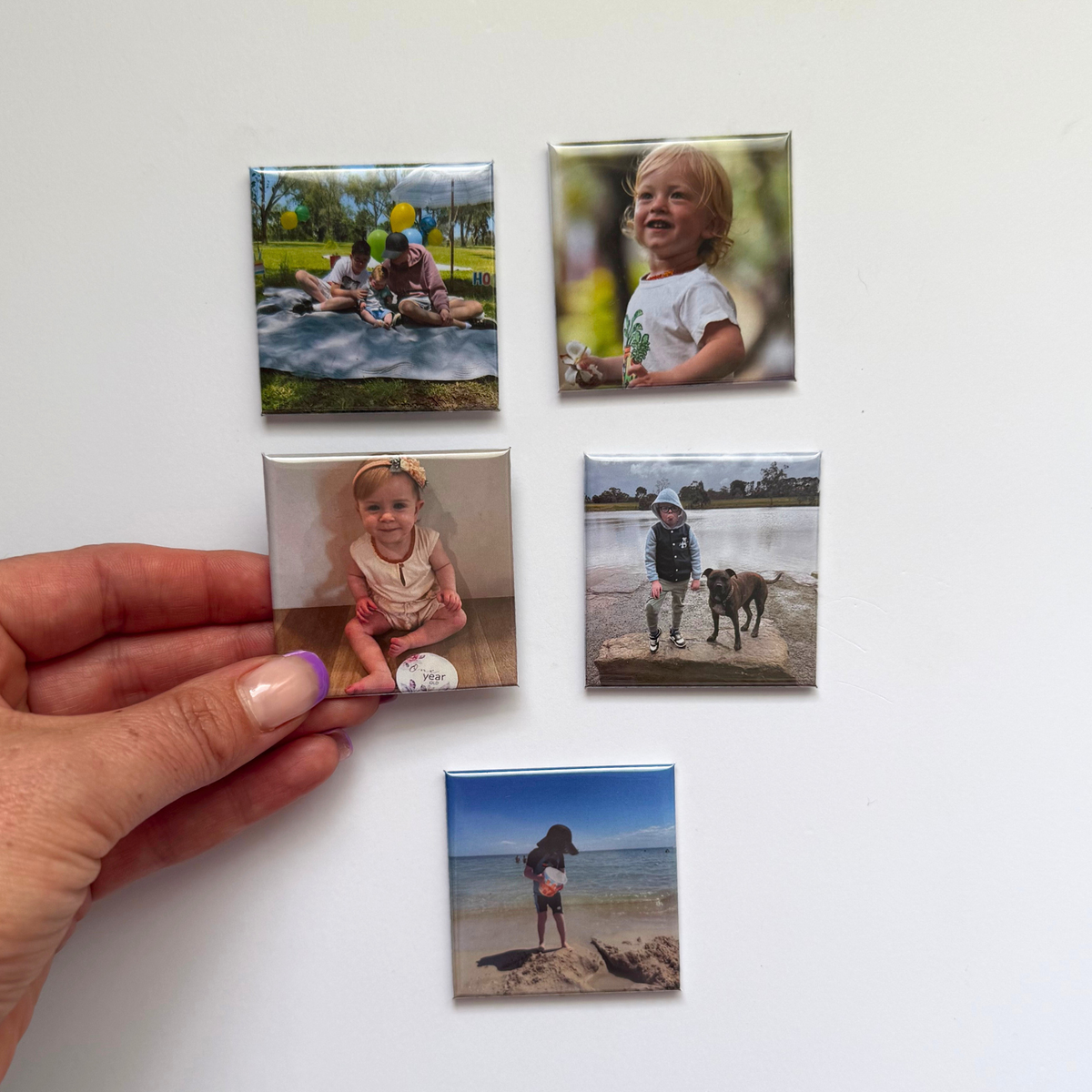 Hand holding a custom 50mm photo magnet from the Yesterday Club five-photo set