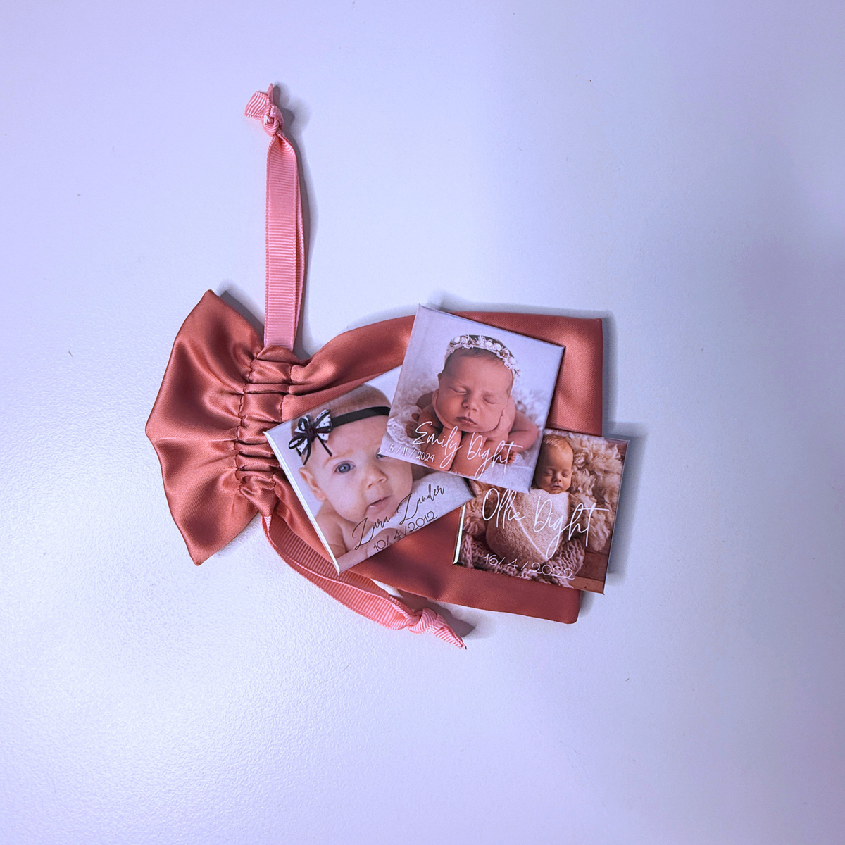 Three personalised birth announcement photo magnets with pink satin pouch and ribbon — custom newborn keepsake magnets handmade in Melbourne Australia