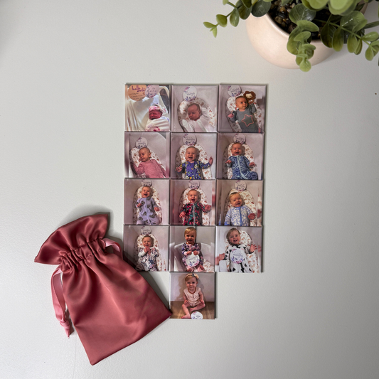 Set of 13 custom baby milestone magnets from newborn to 12 months with pink satin pouch — personalised baby keepsake magnets handmade in Melbourne Australia