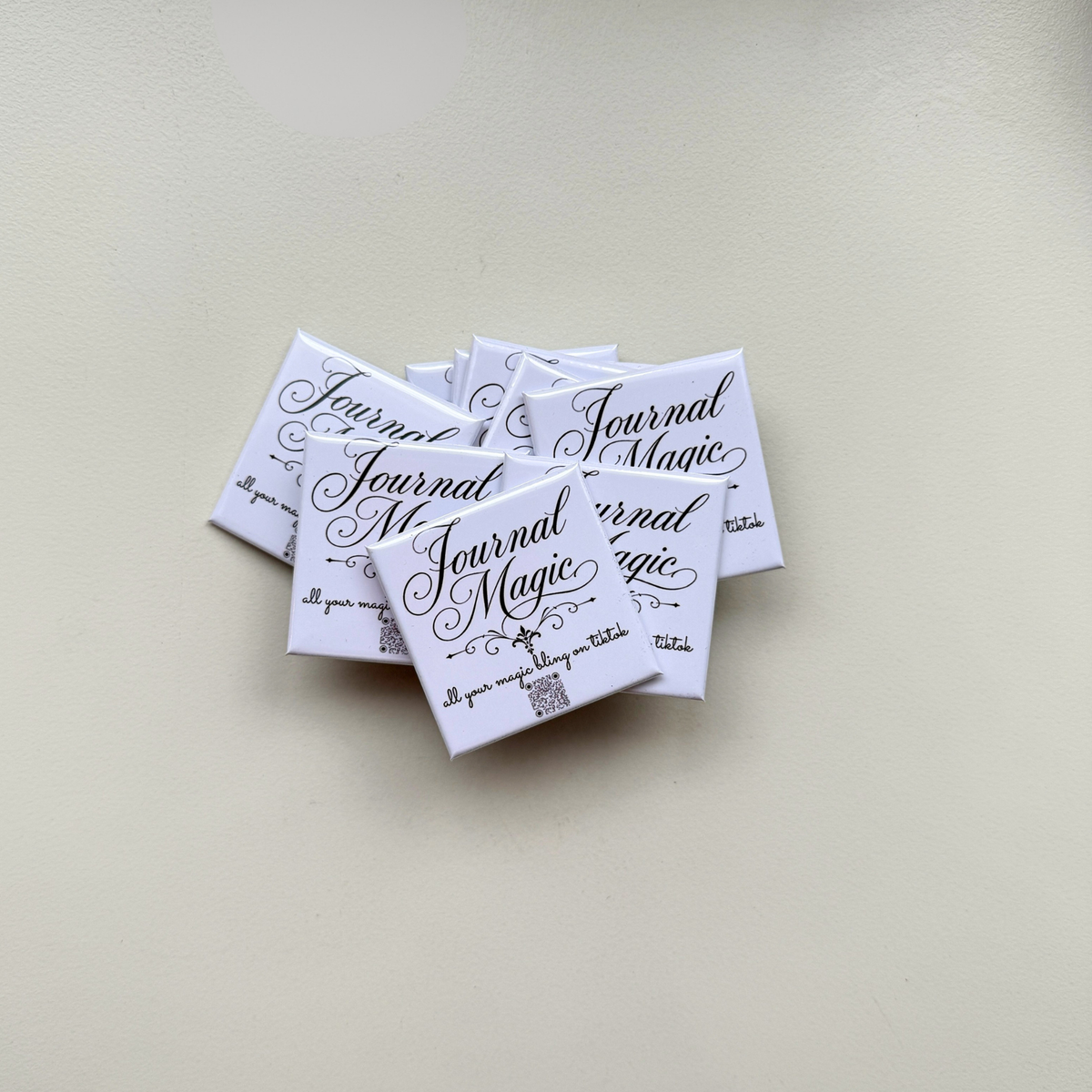 Set of custom branded magnets with Journal Magic logo fanned out — bulk event favour magnets handmade in Melbourne Australia