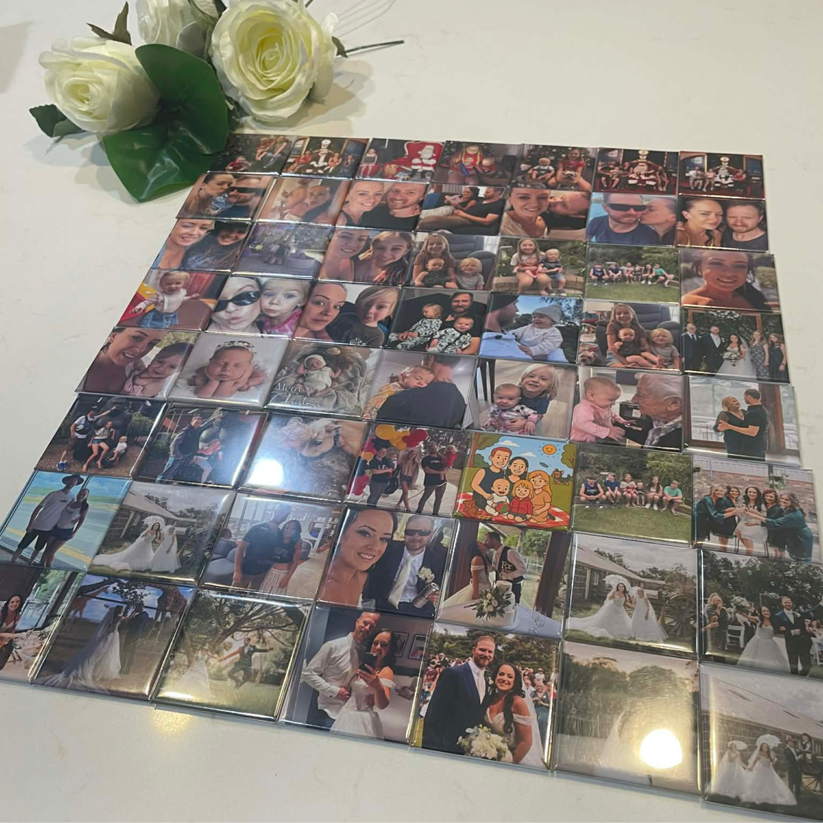 Large set of custom photo magnets laid flat — personalised 50mm fridge magnets handmade in Melbourne Australia