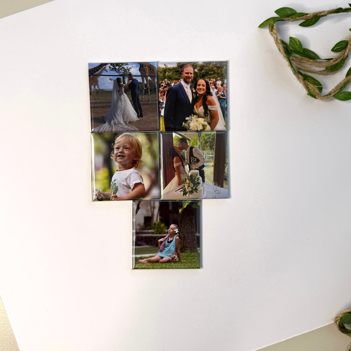  Custom photo magnets displayed on white wall — personalised 50mm fridge magnets with wedding and family photos, handmade in Melbourne