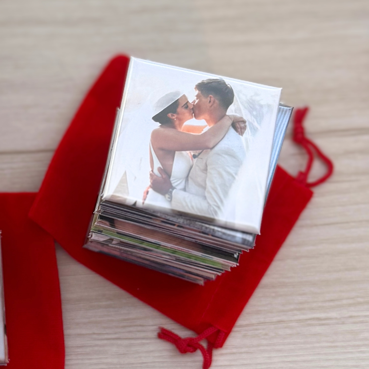  Stack of custom wedding photo magnets with couple kissing — personalised keepsake magnet in red velvet pouch, handmade in Melbourne Australia