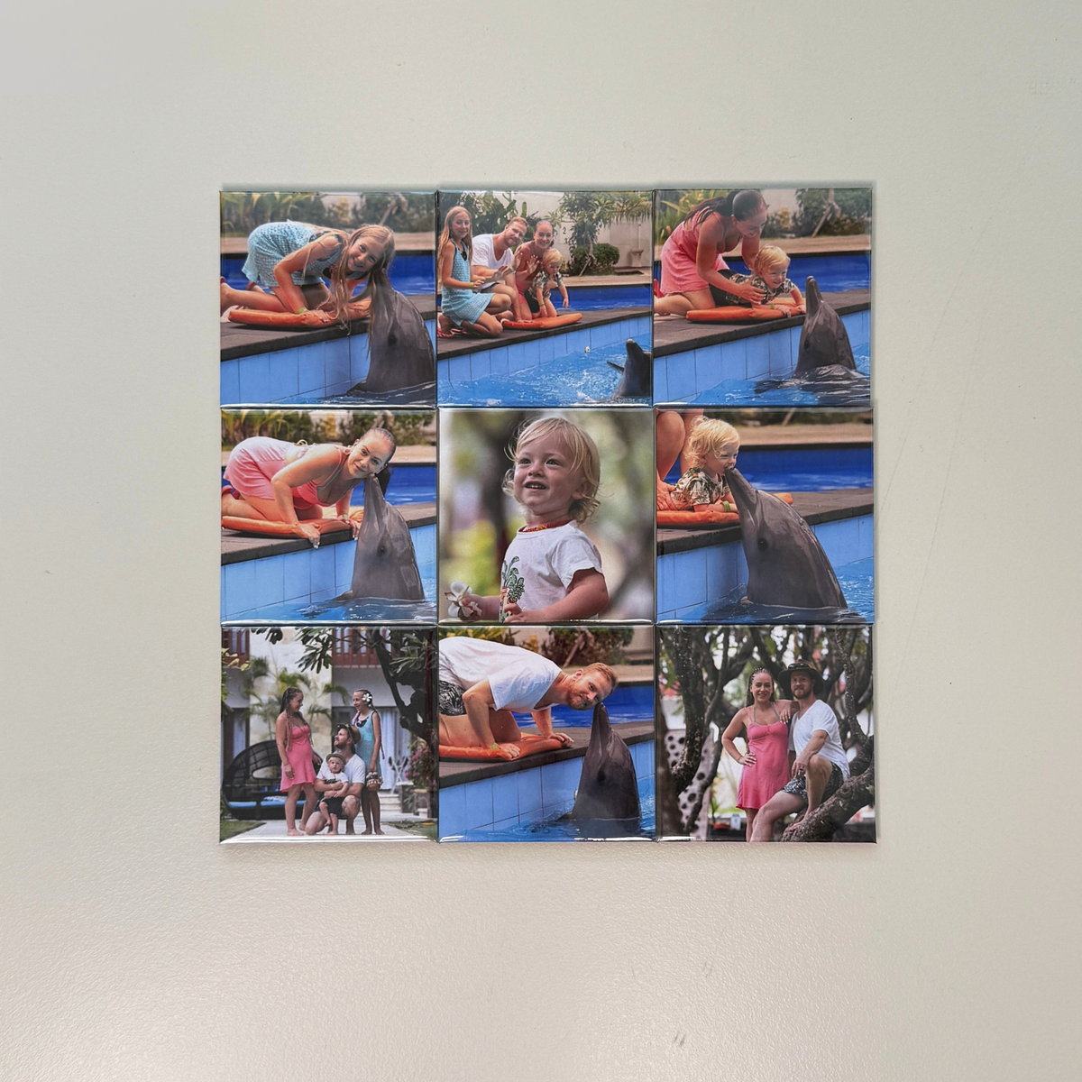 Set of 9 signature 63.5mm custom photo magnets displayed on white wall with family holiday photos — larger personalised fridge magnets handmade in Melbourne Australia